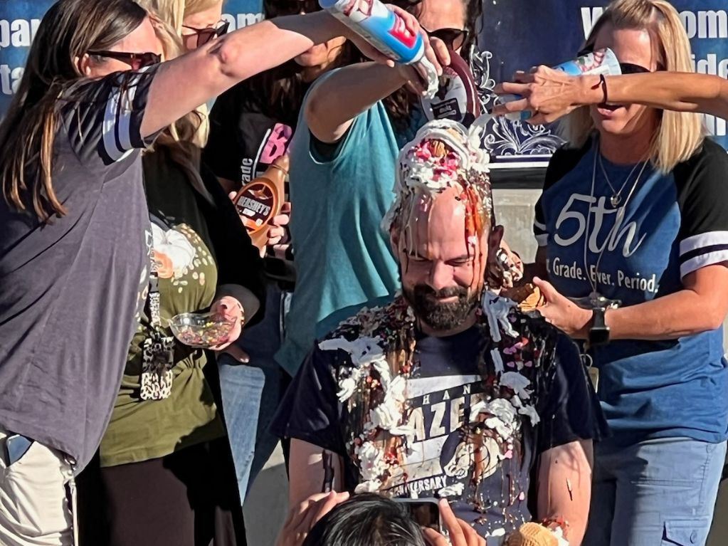 Mr. Norton covered in ice cream toppings